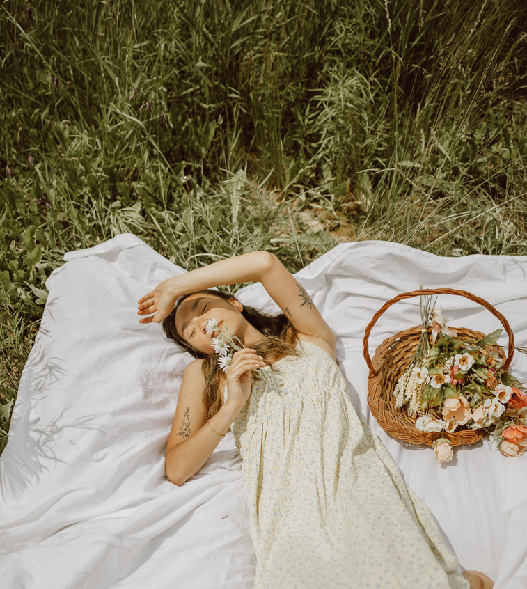 Woman Lying on a Blanket in a Meadow